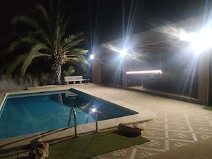 Pool and poolhouse at night