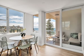 Dining for 6 leading to the balcony overlooking the beach