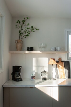 Coffee station with coffee maker, french press, and pour over available.