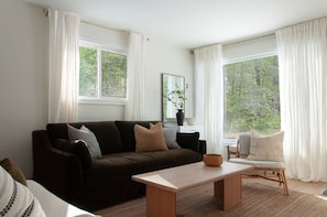 A bright and cozy space with a comfortable full size sofa and lounge seating.