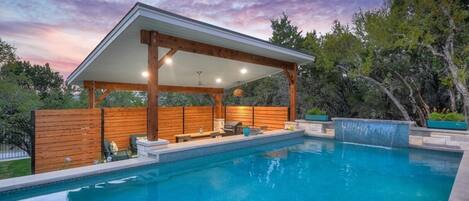 Beautiful lower terrace covered patio with table and seating for 8; bar height area connected to the swim up bar.  Ask us how we can heat up the pool during your stay.