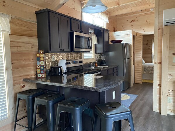 Full kitchen with dishes, silverware, pots, pans, toaster, blender, Kurieg