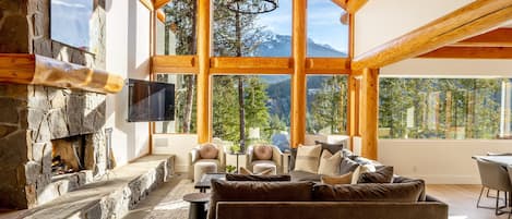 Unwind in the cozy living area, surrounded by breathtaking mountain views