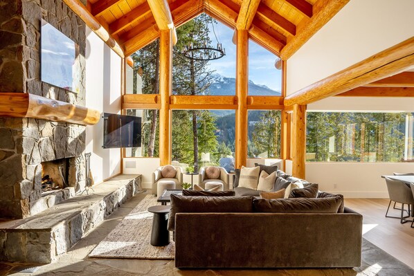 Unwind in the cozy living area, surrounded by breathtaking mountain views