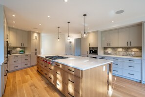 The gourmet kitchen is now equipped with state-of-the-art, high-end appliances