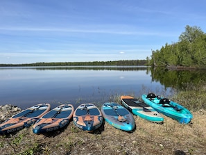 Paddle boards and kayaks are provided for guest use.