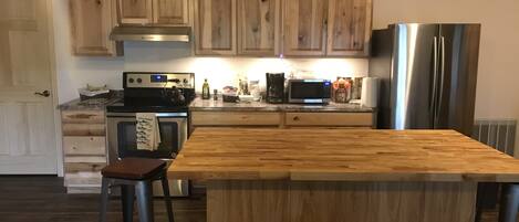 Kitchen stove, island, and fridge