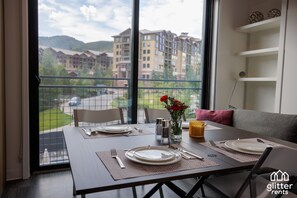 All furniture in the condo is purposefully designed. The tiny coffee table turns into a dining table as you see in this photo. 