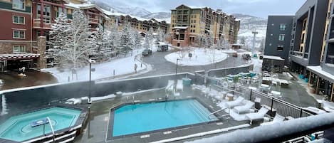 The condo has mountain and pool views. The pool and hot tub are open year-round. This is the view just below your window. 