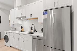 Kitchen appliances include a full-size fridge and dishwasher