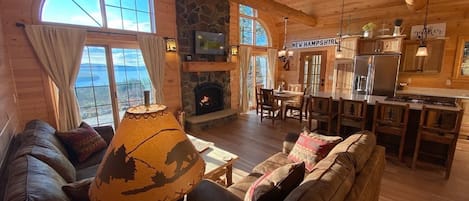 The living room and kitchen area with the gorgeous view out the giant windows.