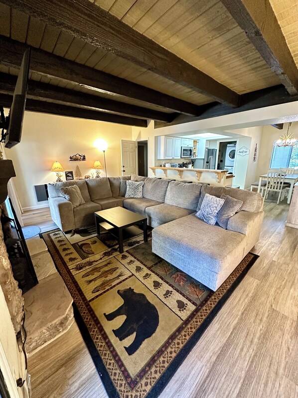 Living room with electric fireplace and Smart TV.