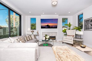 The ground floor living room is professionally appointed for premium comfort and style, including streaming television and gas fireplace.
                