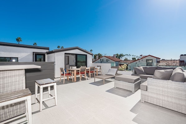 The rooftop deck is expansive and looks out on the idyllic streets of Corona Del Mar and ocean beyond.
                