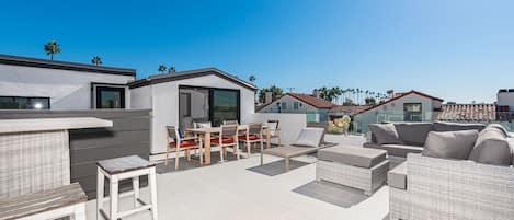 The rooftop deck is expansive and looks out on the idyllic streets of Corona Del Mar and ocean beyond.