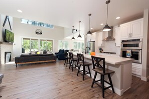 Main Living Space and Kitchen - TV, Gas Fireplace and tons of windows