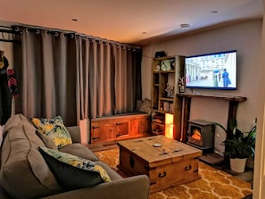 Step inside the cosy lounge, settle down and enjoy a film on the 50 inch tv