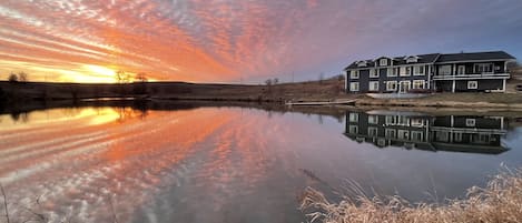 House with pond at sunset