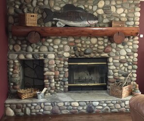 large river rock wood burning fire place