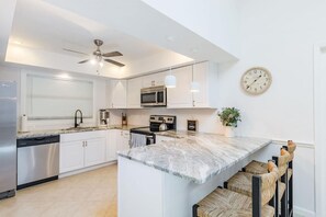 Countertop seating for 3 and a kitchen that opens into the main living area. 