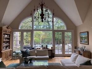 Living Room with Wall of Windows Overlooking the Pool