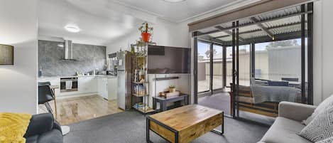 Lounge room with large sliding door access to patio. Open plan living.