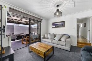 Luxurious couch & large TV with internet & Netflix.