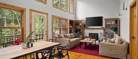 Open concept dining and living space with smart TV and fireplace.