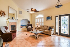 The living room is charmingly decorated with a nautical, beach theme.