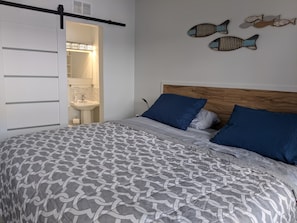 King size bed with half bath. Nightstands with wireless watch/phone chargers.