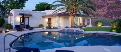 Resort style backyard with private pool, hot tub, lounge chairs, outdoor dining, corn hole, built in grill and fire pit!