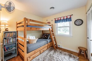 Third bedroom with closet space, kids books, twin over twin bunk bed and twin trundle bed underneath bottom bunk.