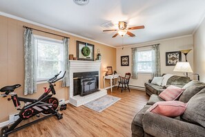 Work & Unwind – A serene den with a plush couch, small workspace, and easy access to the kitchen – perfect for work or relaxation.