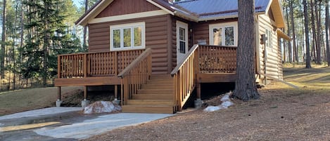 Rustic Cabin with front deck and rear decks nestled in trees.