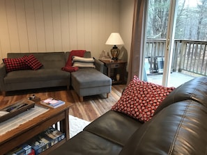 The deck off the living room overlooks a wooded area -
patio chairs provided