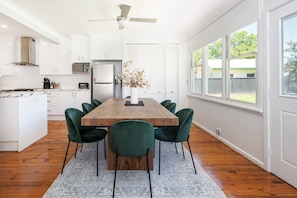  A stylish dining area seamlessly flows from the kitchen and offers a sunny outlook.