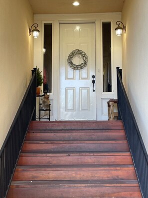 Front entrance features a well lit, covered staircase. 