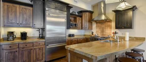 Large kitchen, fully stocked with high-end appliances.