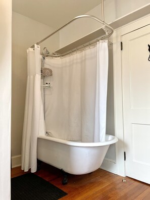 Luxurious soaking tub with shower. With a STURDY grab bar nearby for safety! 