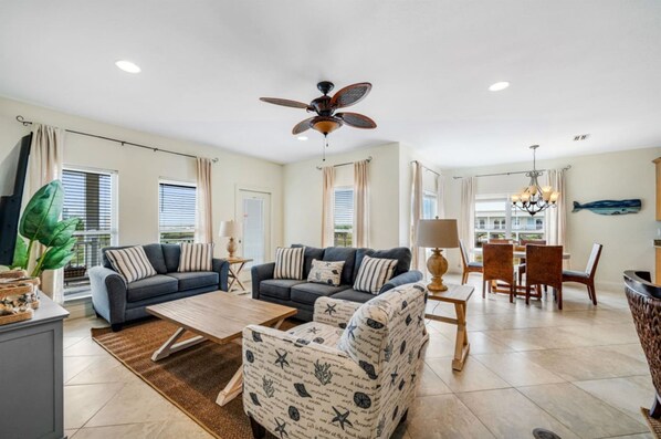 Living room with seating for all, partial ocean views and multiple gathering areas. Board games included! Very clean