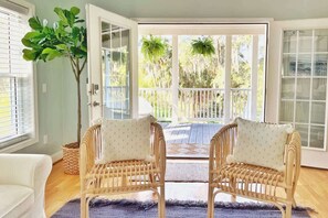 The living room opens to the front porch, with views of the Marsh