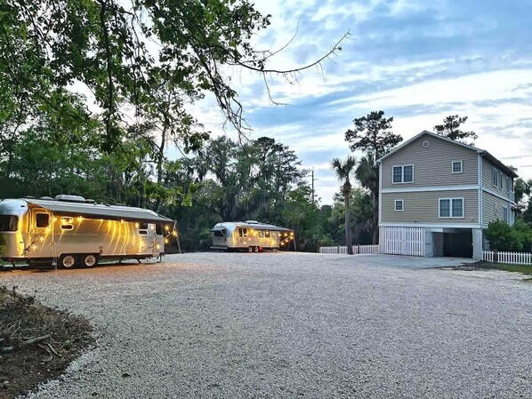 Our "Marsh Compound" includes two modern Airstreams and a four bedroom/four bathroom house.  The entire property includes 1.4 acres of private land where you and your group can relax and use as a hub to explore Savannah and Tybee Island.  Some of the amenities included are a hot tub, a coal grill, and furniture in every outdoor space.