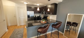 Updated bar stools and kitchen to relax after a long day at work.