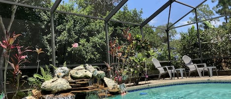 Beautiful heated pool with fountain inside the lanai waiting for you! 