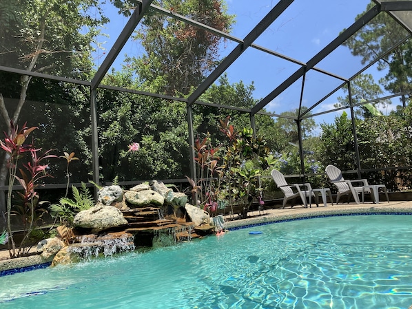 Beautiful heated pool with fountain inside the lanai waiting for you! 