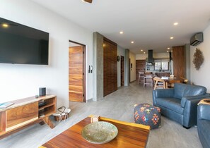 Open-concept living room that flows seamlessly to a private deck and shared BBQ area—perfect for indoor-outdoor living.
