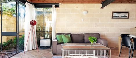 Main lLiving Area with Large windows opening to a shady courtyard