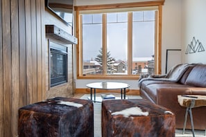 Relax after a day of adventure & and warm up by the fireplace in the cozy living room.