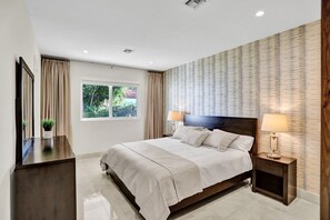 Master bedroom with king bed, walk-in closet, and in-suite bathroom