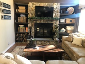 Stone fireplace with Pottery Barn sectional and flat panel tv